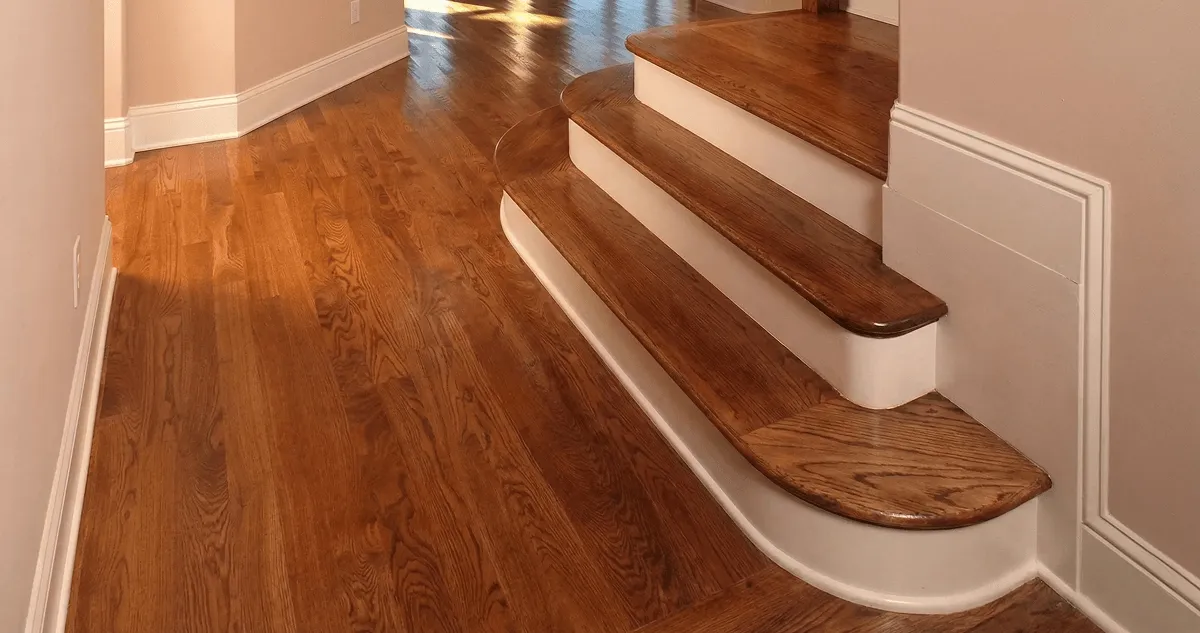 Base floor of a staircase with professionally restored wood flooring in Shreveport LA