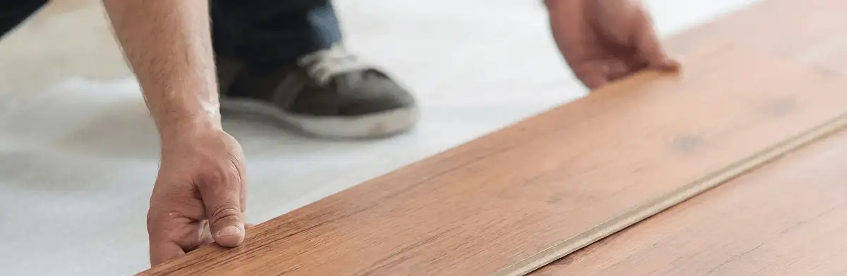A professional installing laminate flooring in Shreveport, LA