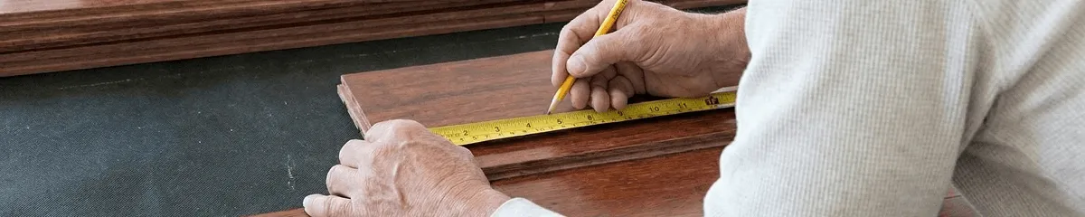 A professional installing wood flooring in Shreveport, LA